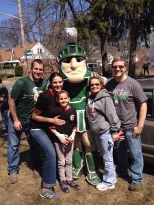 Our employees posing with Sparty the Spartan