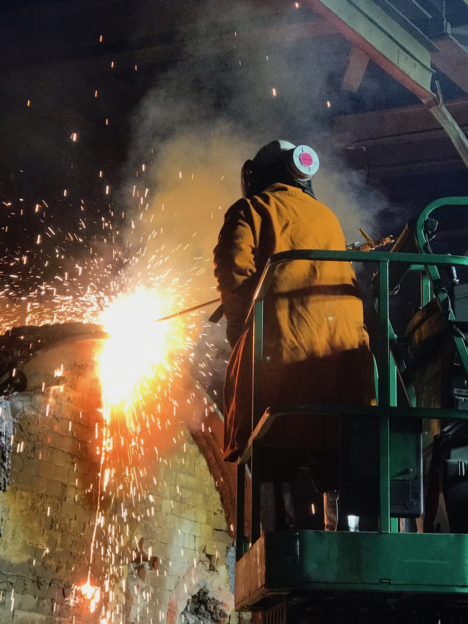 A Schad employee works to remove an induction furnace from an iron foundry.