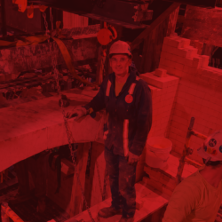 Refractory crew working inside an industrial glass furnace during a full reline project